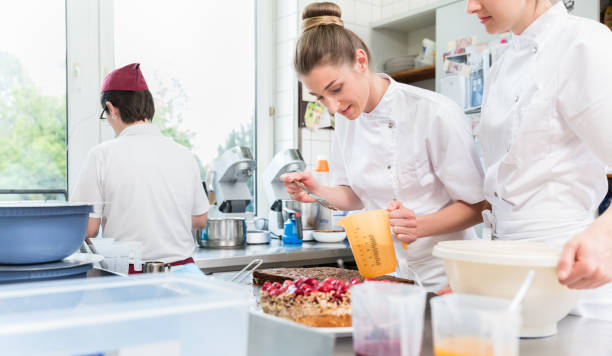 istock Women in confectioner bakery baking cakes 944730738