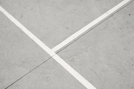 sport field lines closeup - white lines on concrete floor -