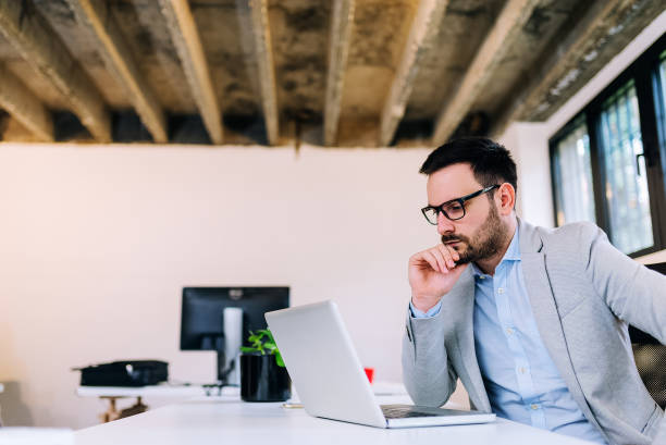 istock Concentrated young man looking at laptop screen. 944733714