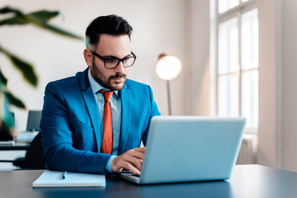 istock Young businessman working with laptop at modern office. 944734106