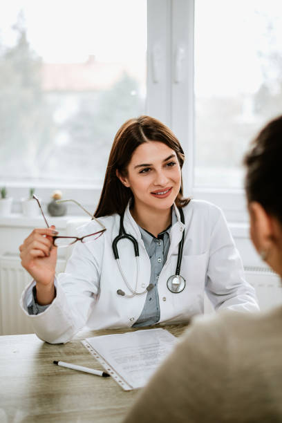 istock Doctor holding spectacles while talking to a patient in the office. 944734138