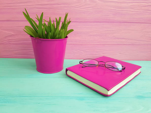 istock book glasses pot with grass on wooden 944734616