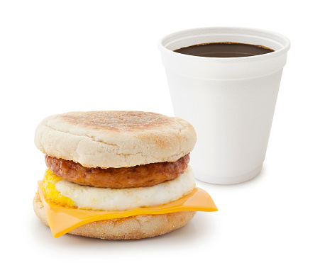 Sausage breakfast sandwich with take out coffee isolated on white (excluding the shadow)