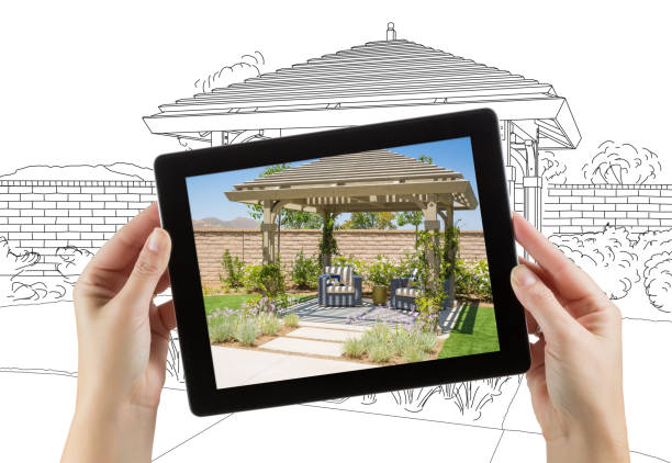 Female Hands Holding Computer Tablet with Photo of Pergola on Screen, Drawing Behind. Female Hands Holding Computer Tablet with Photo of Pergola on Screen, Drawing Behind. patio cover stock pictures, royalty-free photos & images