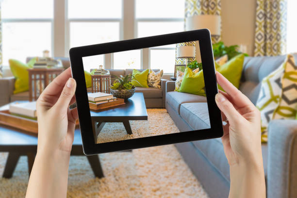 istock Female Hands Holding Computer Tablet In Room with Photo on Screen. 944751432