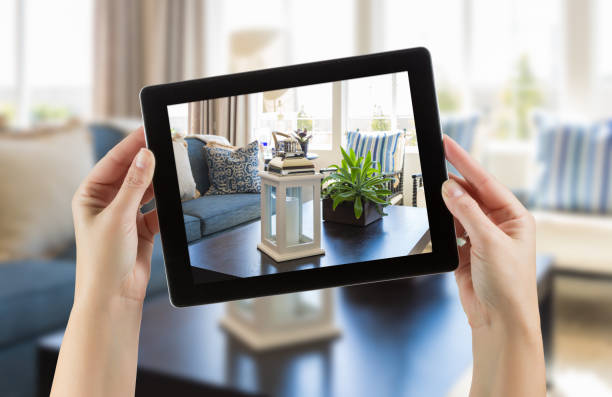 istock Female Hands Holding Computer Tablet In Room with Photo on Screen. 944751480