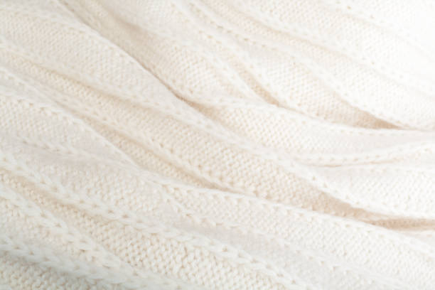 istock Sweater or scarf fabric texture large knitting. Knitted jersey background with a relief pattern. Wool hand- machine, handmade 944755756