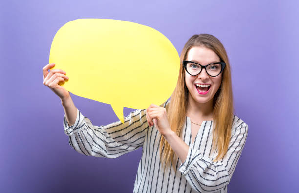 istock Young woman holding a speech bubble 944756490