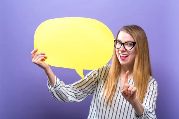 istock Young woman holding a speech bubble 944756514