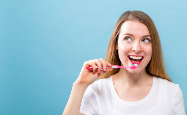 istock Young woman holding a toothbrush 944761004