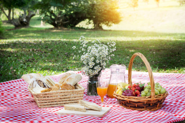 istock Food And Drink On Picnic Blanket At Park 944767046