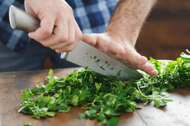 istock Close-up male hands chopping fresh parsley 944774984