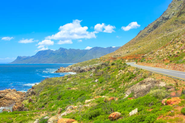 Route 44 False Bay Scenic coastal Route 44 or Clarence Drive on False Bay near Cape Town between Gordon's Bay and Pringle Bay in Western Cape, South Africa. Hottentots Holland Mountain range on background. Summer season gordons bay stock pictures, royalty-free photos & images