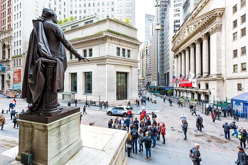 New York City, USA - October 30, 2017: Wall street NYSE stock exchange building and Federal Hall Memorial statue of George Washington, broad st in NYC Manhattan, lower financial district downtown