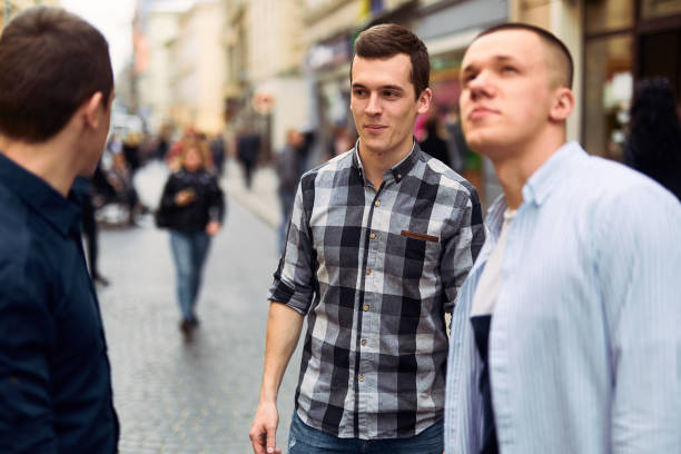 istock Three man talk on the street about business 944779110