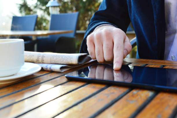 Businessman Using Digital Tablet in Outdoor Restaurant