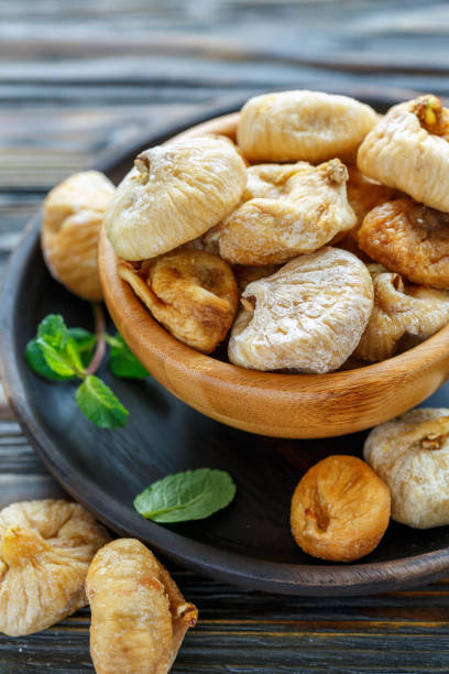 istock Sweet dried figs in a wooden bowl. 944782732