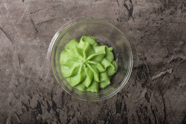istock Bowl with wasabi on a black concrete background 944786466