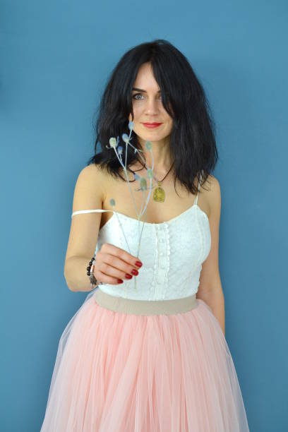 istock Woman with a flower in her hand 944787002