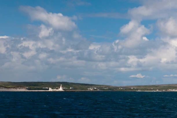 Straw Island Lighthouse, entrance to Killeany Bay, Inishmore View from Doolin Ferry travelling Galway Bay to Inishmore, looking southwest toward the lighthouse of Straw Island.  Aran Islands, County Galway, Republic of Ireland.  The lighthouse position is: 53°07.065' North 09°37.840' West michael stephen wills aran stock pictures, royalty-free photos & images