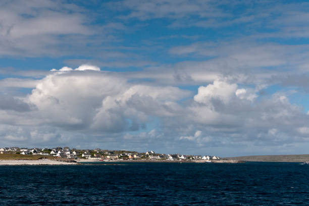 View of Inisheer from Doolin Ferry Looking west toward Inisheer as the Doolin Ferry approaches the dock at Caherard.  The island of Inishmann to the right.  Inisheer, Aran Islands, County Galway, Republic of Ireland michael stephen wills aran stock pictures, royalty-free photos & images