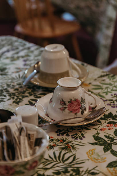 istock Close up of vintage teacups and saucers on a table. 944793642