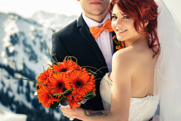 istock Wedding snowboarders couple just married at mountain winter 944794512
