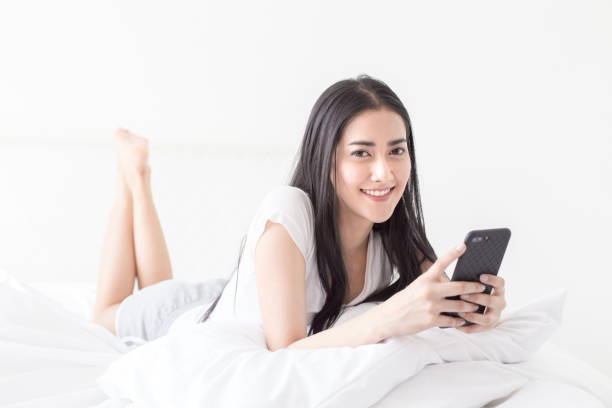 istock Asian woman using smartphone at home. People with technology concept. 944799952
