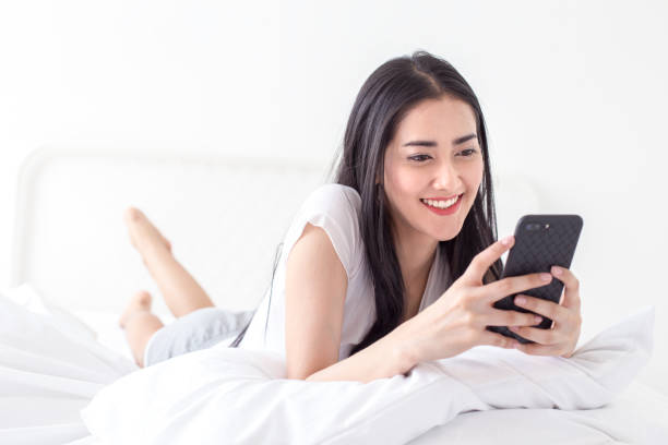 istock Asian woman using smartphone at home. People with technology concept. 944800226