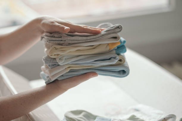 istock Mother sorting newborn baby clothing 944814826