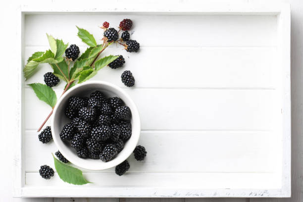 istock Fresh raspberries bowl in white wooden tray 944815792