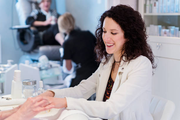 istock Young woman having a manucure in a beauty spa. 944815944