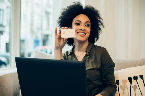 istock Happy woman with a credit cardop 944817006