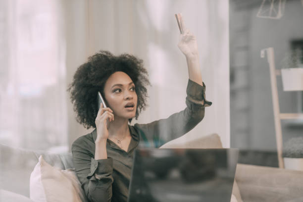 istock Woman using mobile phone and holding credit card 944818808