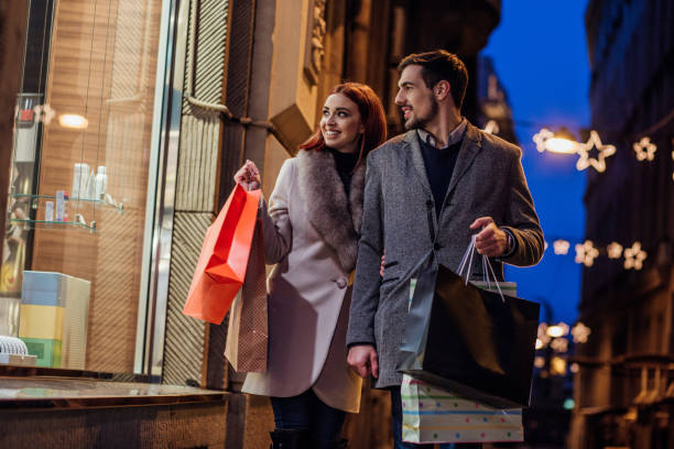 istock Couple passing by a window shop 944819128