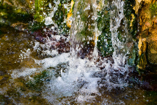 istock Quickly flowing mountain stream, close-up flowing water from the rock 944819648