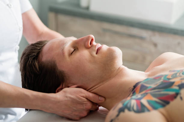 istock Neck massage to young man in beauty spa. 944822496