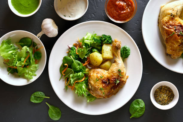 istock Chicken leg with potato and green salad 944822548