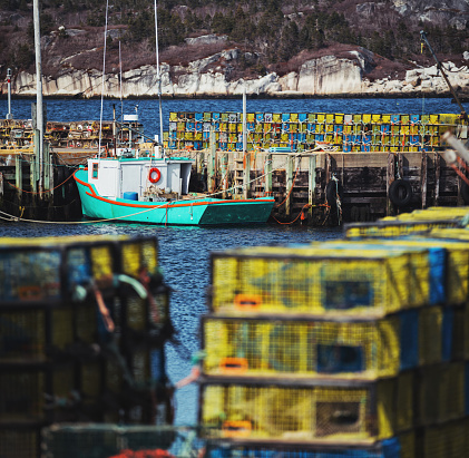 Nova Scotian fishing village wharf stacked with lobster traps.