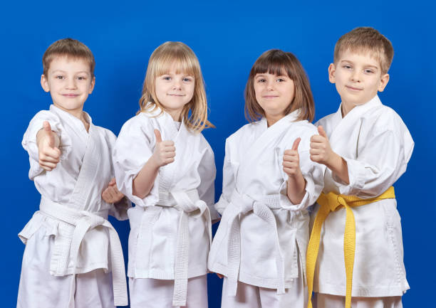 istock Four cheerful athlete shows thumb super 944830062