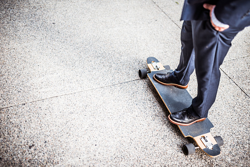 Businessman skateboarding to his workplace