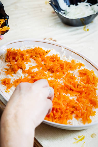 istock preparing russian traditional salad 'herring under fur coat' 944831188
