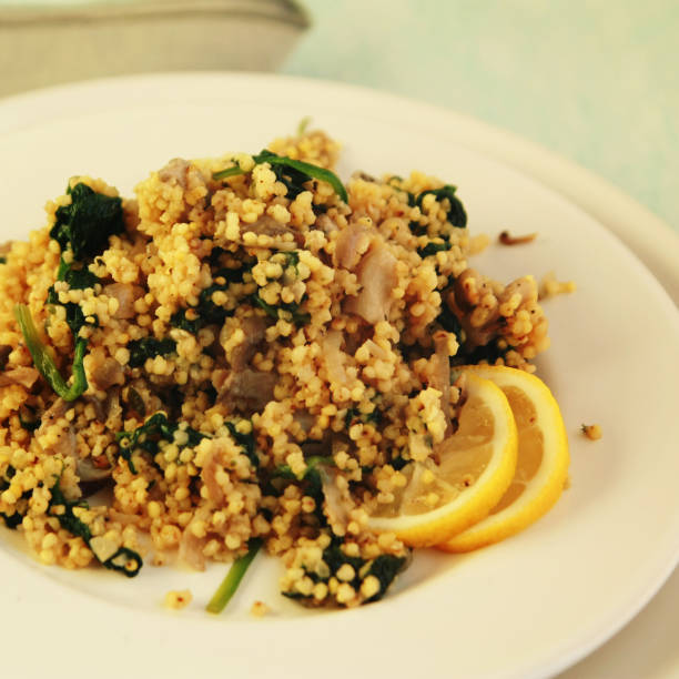 Millet with mushrooms and spinach. Vegan dish.