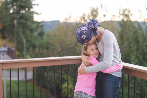 istock Mother with cancer hugging her daughter 944834560