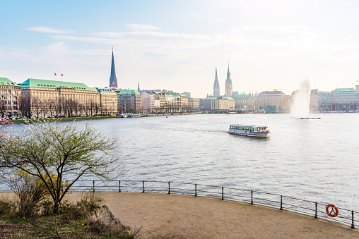 Alster Lake in Hamburg, Germany with Jungfernstieg and townhall in background on sunny spring day
