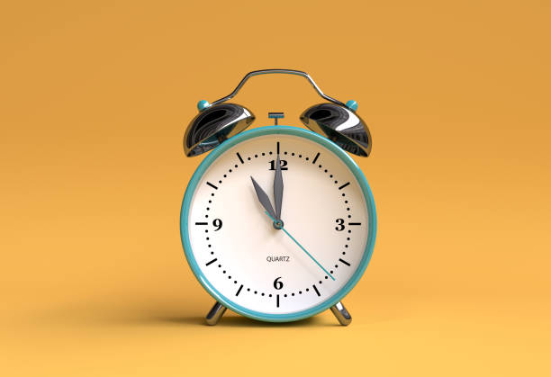 istock old alarm clock on yellow background - 11 o'clock - 3d illustration rendering 944837900