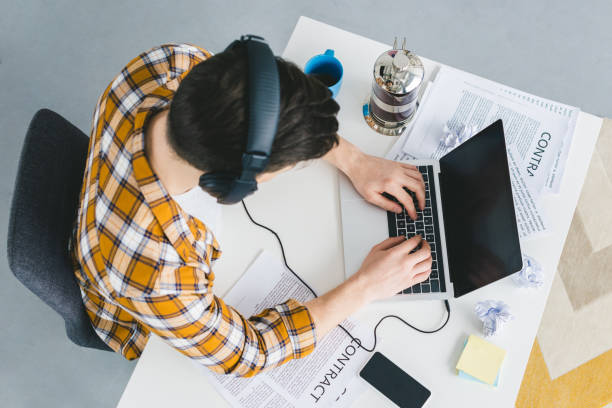 istock Businessman working by table with laptop at home office 944847122