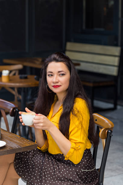 istock Beautiful female in coffee shop 944847252