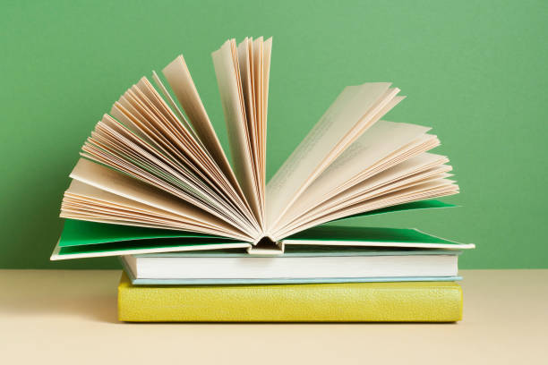 istock Open book, hardback books on wooden table. Education background. Back to school. 944852368