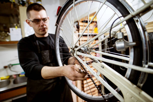 istock Professional focused man checking if bicycle wheelchain is properly set. 944855170